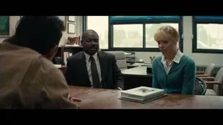 three people conversing at office desk — Interstellar