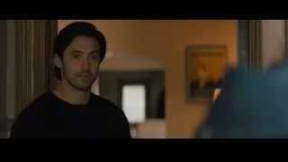 man standing in dimly lit hallway — Creed 2