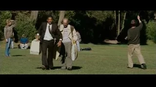 Two men walking in park with umbrella — The Persuit of Happyness
