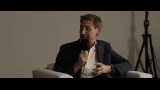 Man in suit speaking into microphone — F1