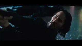 man with beard holding gun in dark room — John Wick: Chapter 4