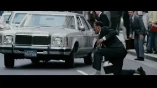 man in suit kneeling on street — The Persuit of Happyness