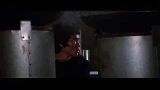 Bruce Lee shirtless holding metal cylinder in dim room — Bruce Lee: Enter The Dragon