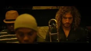 Three men playing instruments in dimly lit music studio — Whiplash