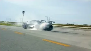 Black Koenigsegg driving fast on highway — Sports Cars