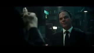 man in suit sitting at a bar — Deadpool