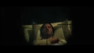 Man looking through sniper rifle in dark room — John Wick