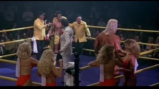 People in wrestling ring with microphones — Rocky III