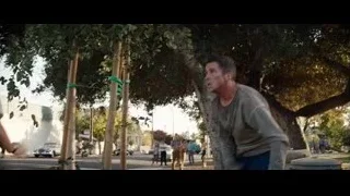 Man running with metal shield on street — Ford v Ferrari
