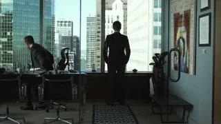 two men in suits in office with city view — Suits