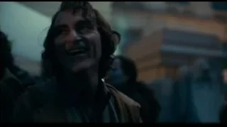 police officer confronting protesters at night — Joker