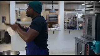man in green beanie pointing at oven — The Bear