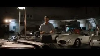 men looking at tablet in garage — Ford v Ferrari