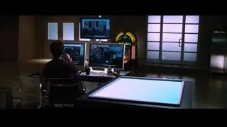 man working at desk with multiple monitors — Iron Man