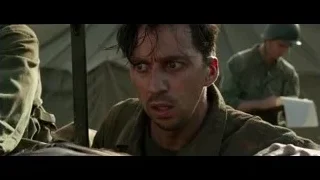 Wounded person on stretcher with military man — Hacksaw Ridge