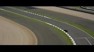 Two black cars racing on curved track — F1