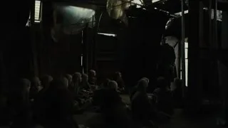 Man in suit addressing people on floor — Blade Runner 2049