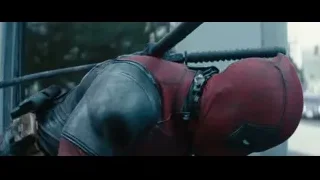 Deadpool holding gun on city street — Deadpool 2