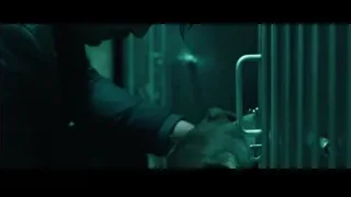 man petting dog in cage — John Wick