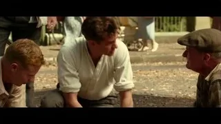 three men sitting on ground in park — Hacksaw Ridge
