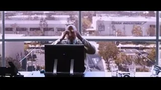 bald man at desk by window with cityscape — Iron Man
