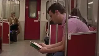 Man reading book on subway train — Screened Out