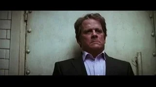 Man in suit standing by metal door — Batman: The Dark Knight