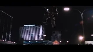 Iron Man fighting in a city street at night — Iron Man
