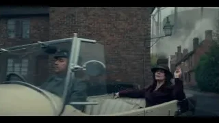 Vintage car driving on street with brick buildings — Peaky Blinders