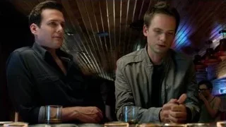 two men conversing at a bar — Suits