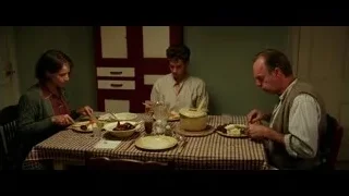 Three people at dining table in dimly lit room — Hacksaw Ridge