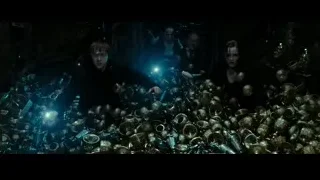 Young man holding blue light in dark room — Harry Potter and the Deathly Hallows 2