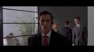 Man in suit walking down hallway — American Psycho