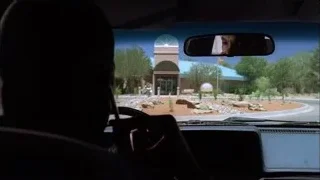 Car interior driving past domed building — Breaking Bad