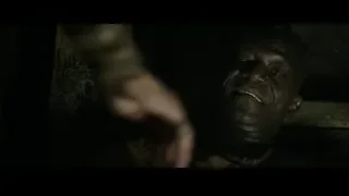 Man holding stick in dark stone room — Gladiator 2