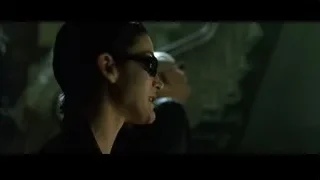 Woman in black jacket and sunglasses — The Matrix