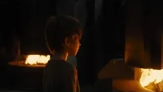 young boy standing by fireplace — Blade Runner 2049