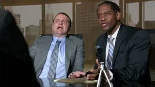 two men conversing at office desk — Suits