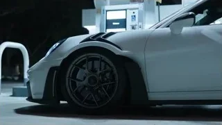 White Porsche parked at gas station — Sports Cars