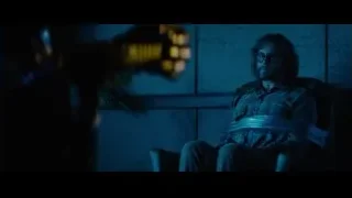 man in plaid shirt in dimly lit room — Deadpool 2