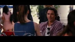 man and woman conversing at table — Batman: The Dark Knight Rises