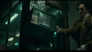 man in dimly lit room with poster — Joker