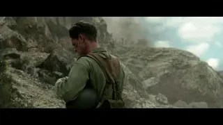 bloodied man in military uniform on rocky cliff — Hacksaw Ridge