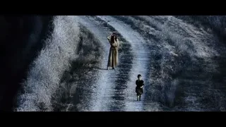 Two people walking on dirt road by waterfall — Gladiator