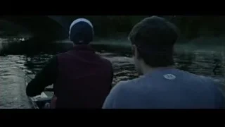 two men rowing on river at night — The Social Network