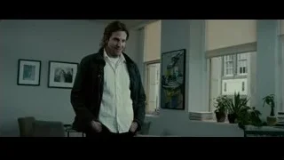 man standing in living room looking out window — Limitless