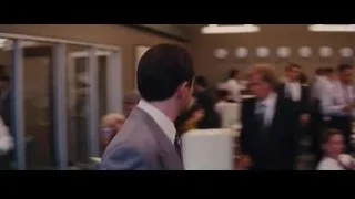 man in suit standing in office — The Wolf Of Wall Street