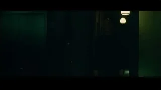bald man in dark room with green walls — Whiplash