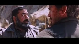 two men conversing in rocky outdoor setting — Iron Man