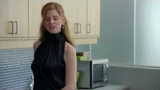 Woman in kitchen looking at camera — Suits